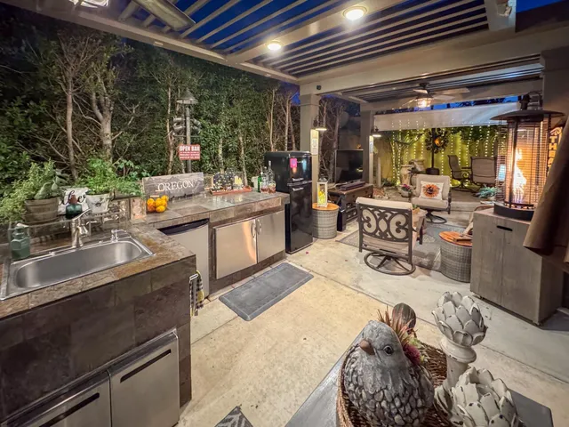a living room with patio furniture and a flat screen tv