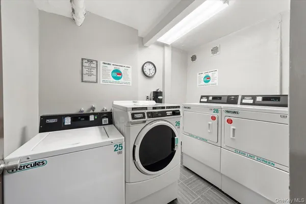 a utility room with dryer washer and a view of living room