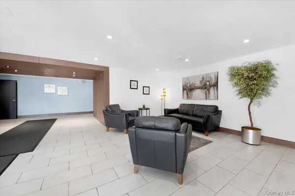 a living room with furniture and a potted plant