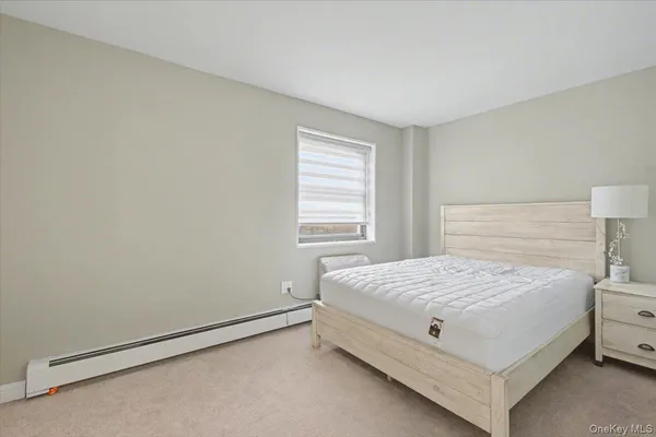 a bedroom with a bed and a lamp