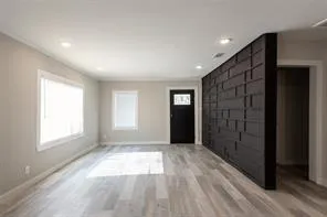 an empty room with windows and closet