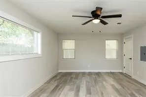 a view of empty room with ceiling fan