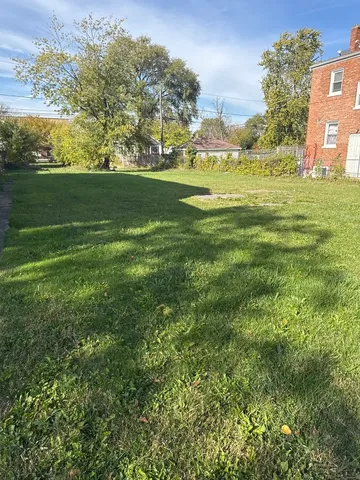 a view of outdoor space with green field and trees