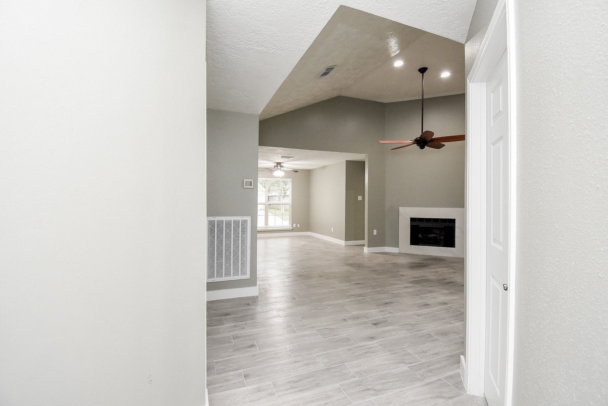 17330 Modbury Drive Spring, TX 77379 - Photo 6 of 30 Bright and welcoming entryway with elegant Ceramic wood-look tile flooring leads into a cozy office space which can be used as a room and ample natural light.