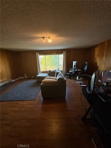 a living room with furniture a air conditioner vent and a window