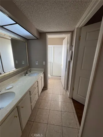 a bathroom with a double vanity sink and mirror