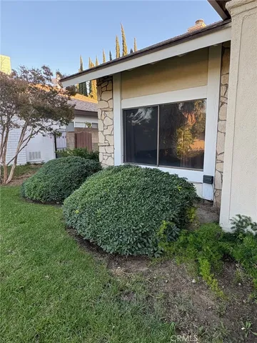 a view of a house with a small yard and a large window