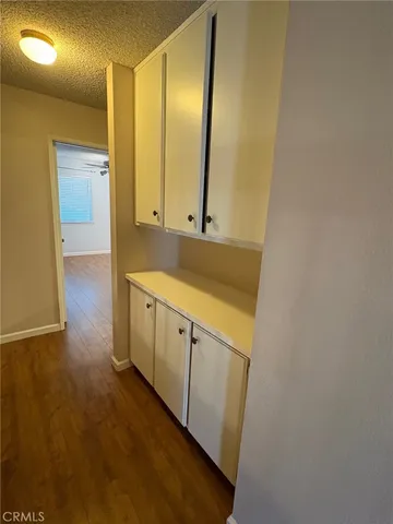 a view of a kitchen with sink and cabinets