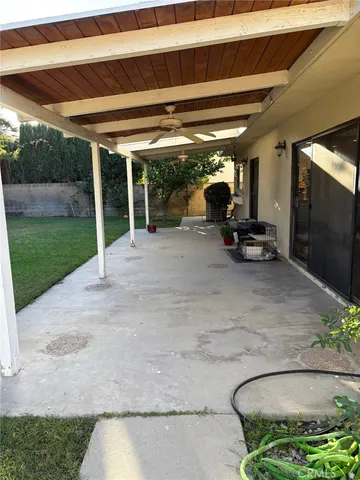 a view of a porch with furniture and backyard