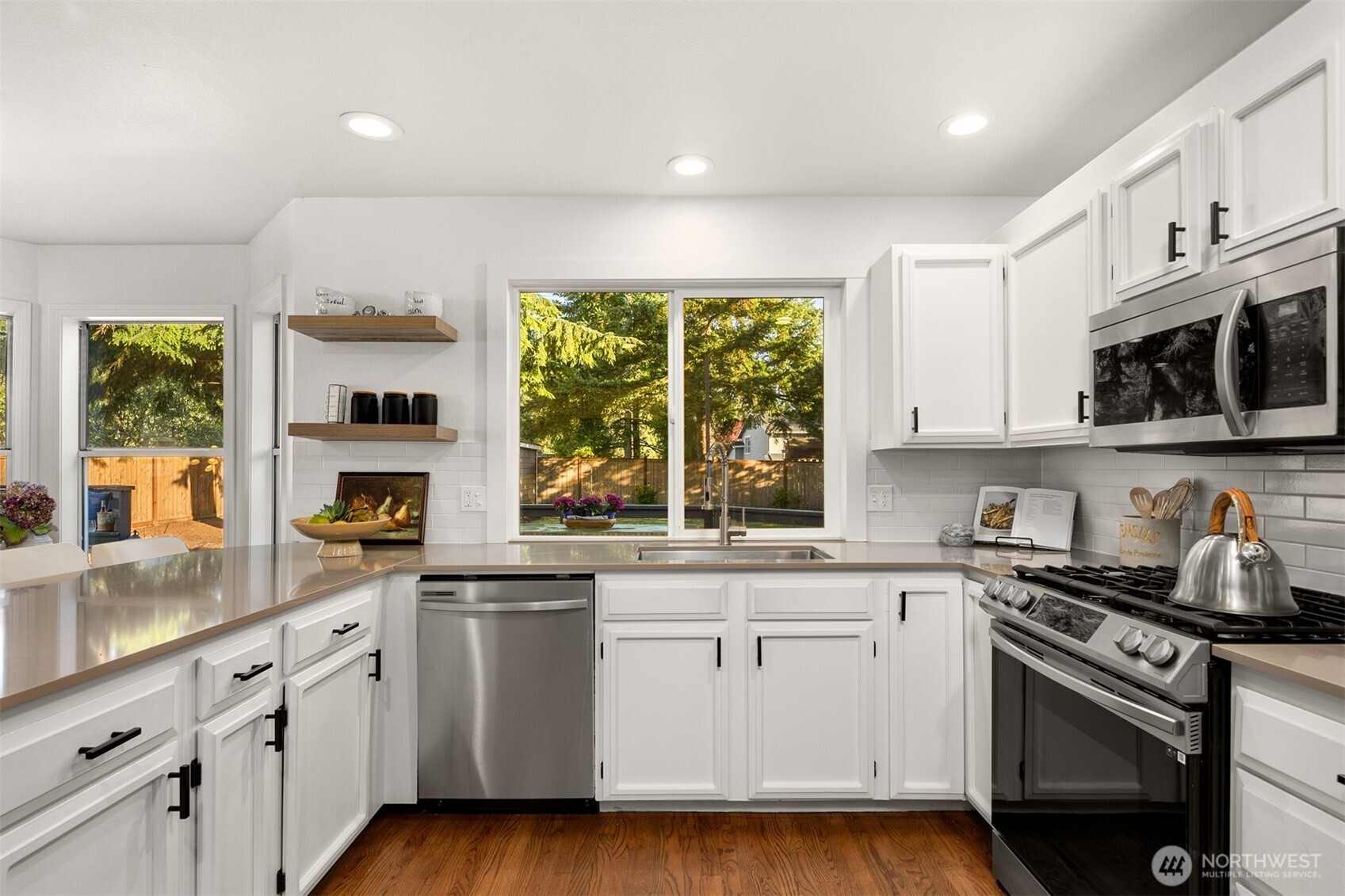 3207 212th Street Southeast Bothell, WA 98021 - Photo 14 of 40 a kitchen with stainless steel appliances a white stove top oven sink and window