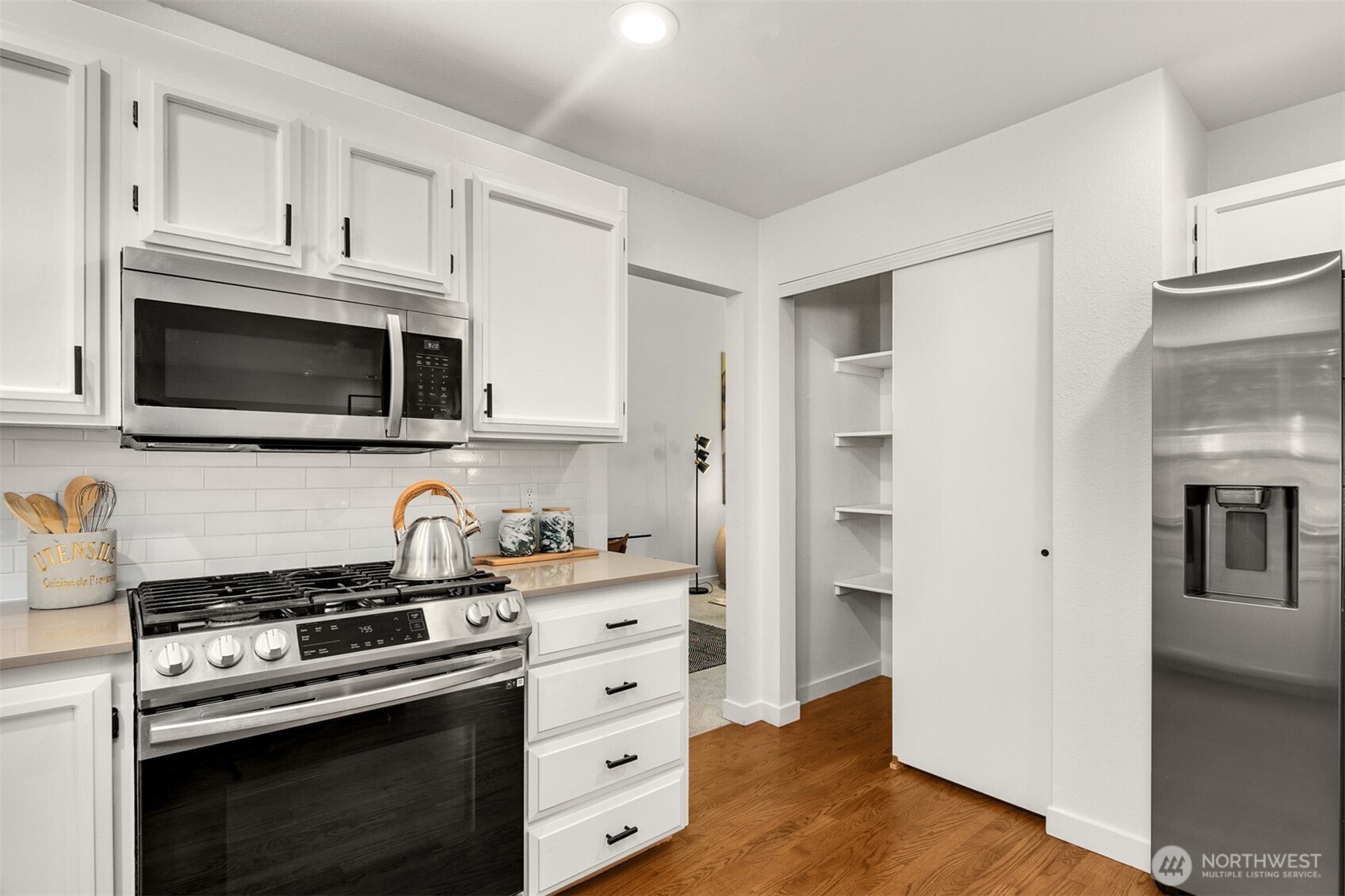 3207 212th Street Southeast Bothell, WA 98021 - Photo 15 of 40 a kitchen with cabinets stainless steel appliances and wooden floor