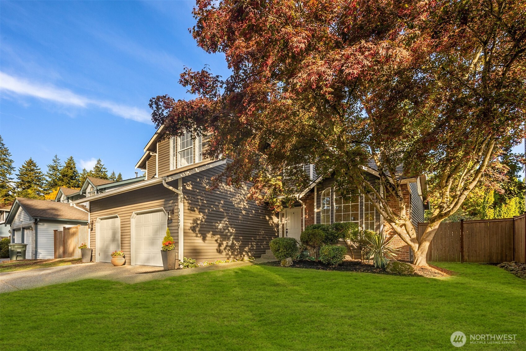 3207 212th Street Southeast Bothell, WA 98021 - Photo 3 of 40 a front view of a house with a garden