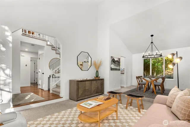 a living room with furniture a clock and a table