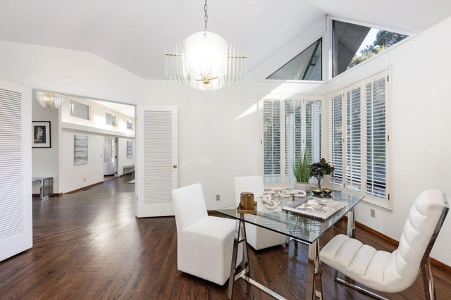 a kitchen with stainless steel appliances granite countertop a sink refrigerator and cabinets