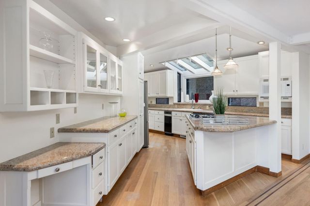 a kitchen with stainless steel appliances granite countertop a stove and a sink