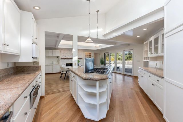 a kitchen with stainless steel appliances granite countertop sink stove and refrigerator