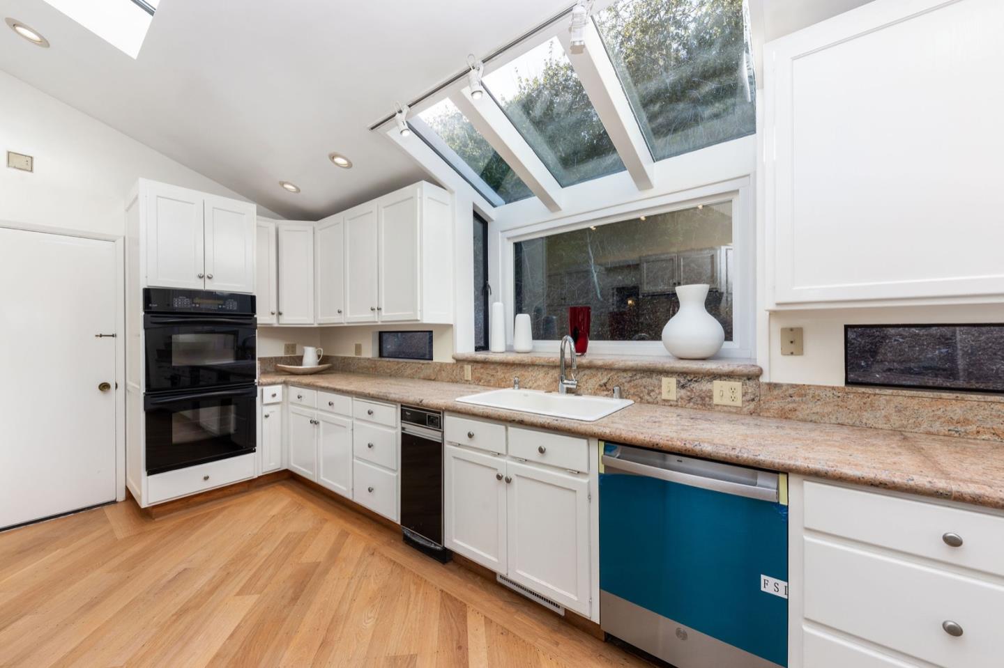 440 Remillard Drive Hillsborough, CA 94010 - Photo 22 of 47 a kitchen with stainless steel appliances granite countertop a sink and cabinets with wooden floor