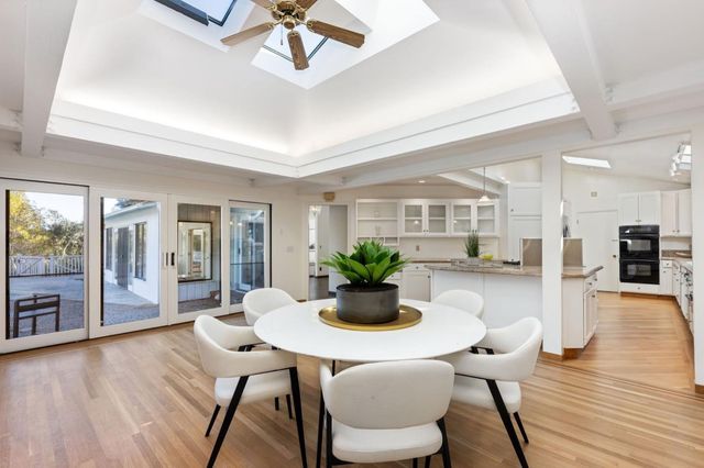 a dining room with furniture and wooden floor