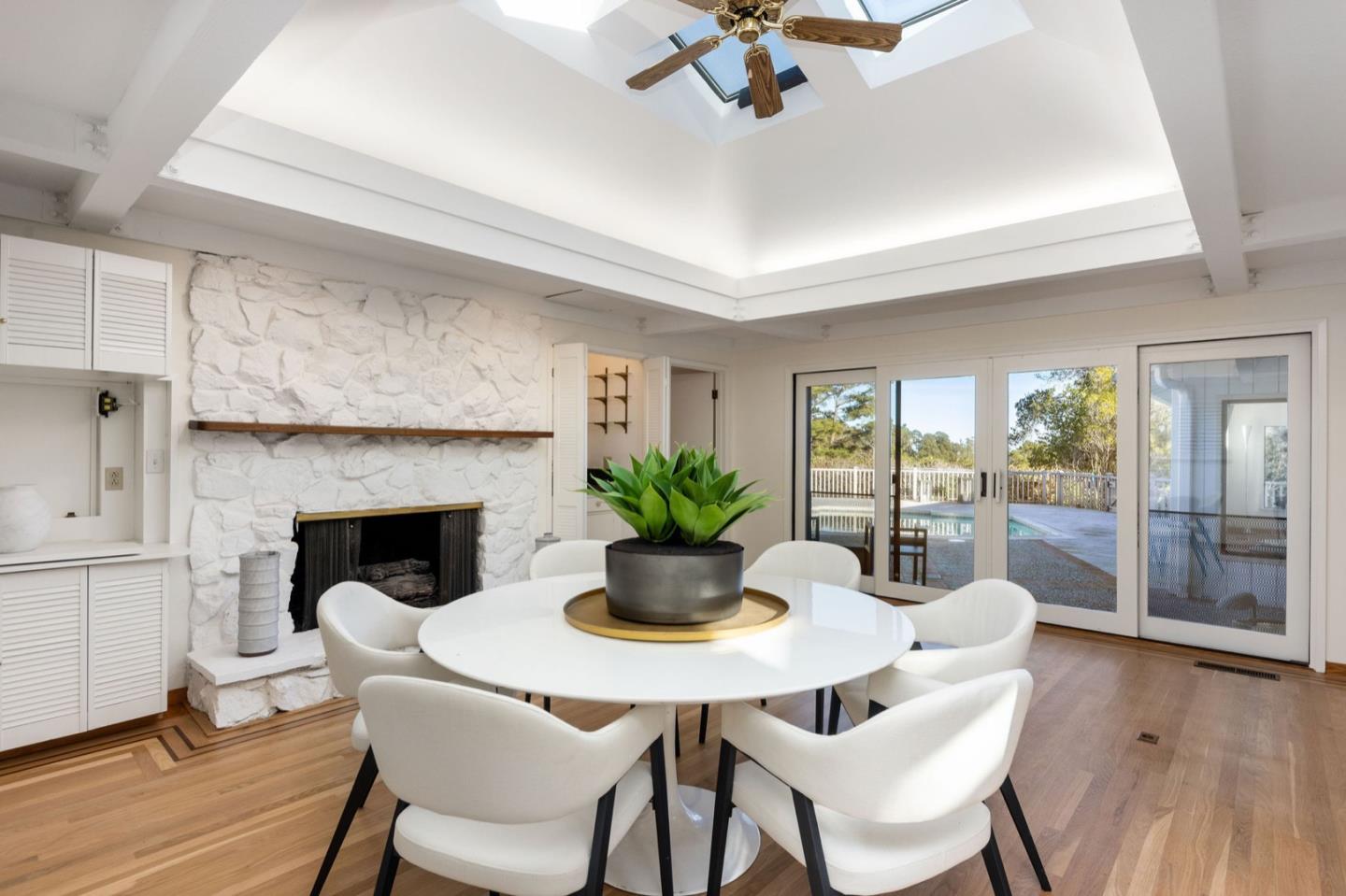 440 Remillard Drive Hillsborough, CA 94010 - Photo 24 of 47 a dining room with furniture potted plants and wooden floor
