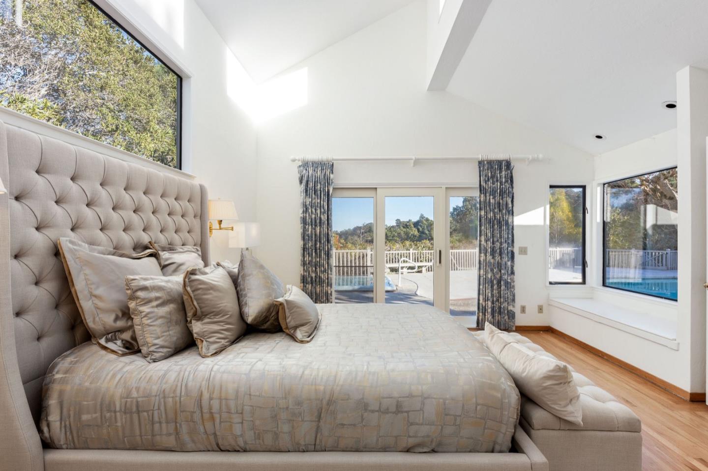 440 Remillard Drive Hillsborough, CA 94010 - Photo 28 of 47 a bedroom with a large bed and a large window with outer view