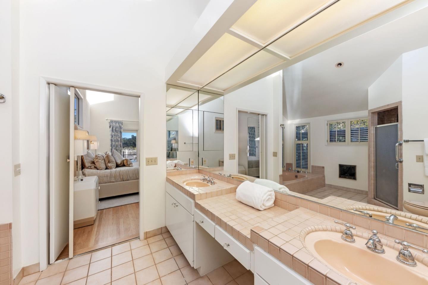 440 Remillard Drive Hillsborough, CA 94010 - Photo 33 of 47 a bathroom with a granite countertop double vanity sink and a mirror