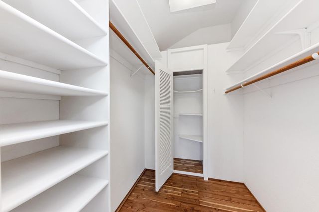a large bed sitting in a bedroom next to a window