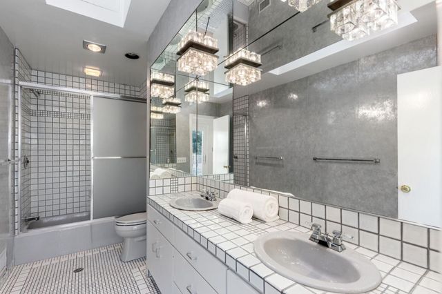 a room with a bed and glass door