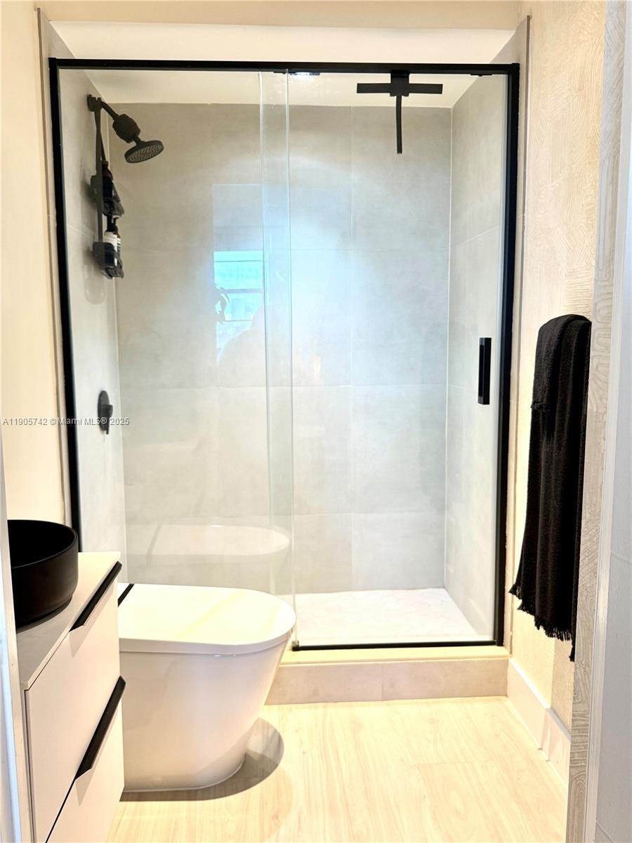 2829 Indian Creek Drive, Unit 603 Miami Beach, FL 33140 - Photo 15 of 28 a bathroom with a shower and a toilet