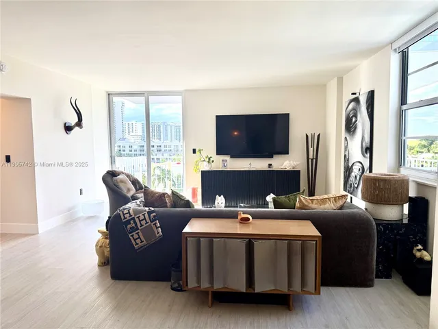 a living room with a couch a lamp and a flat screen tv