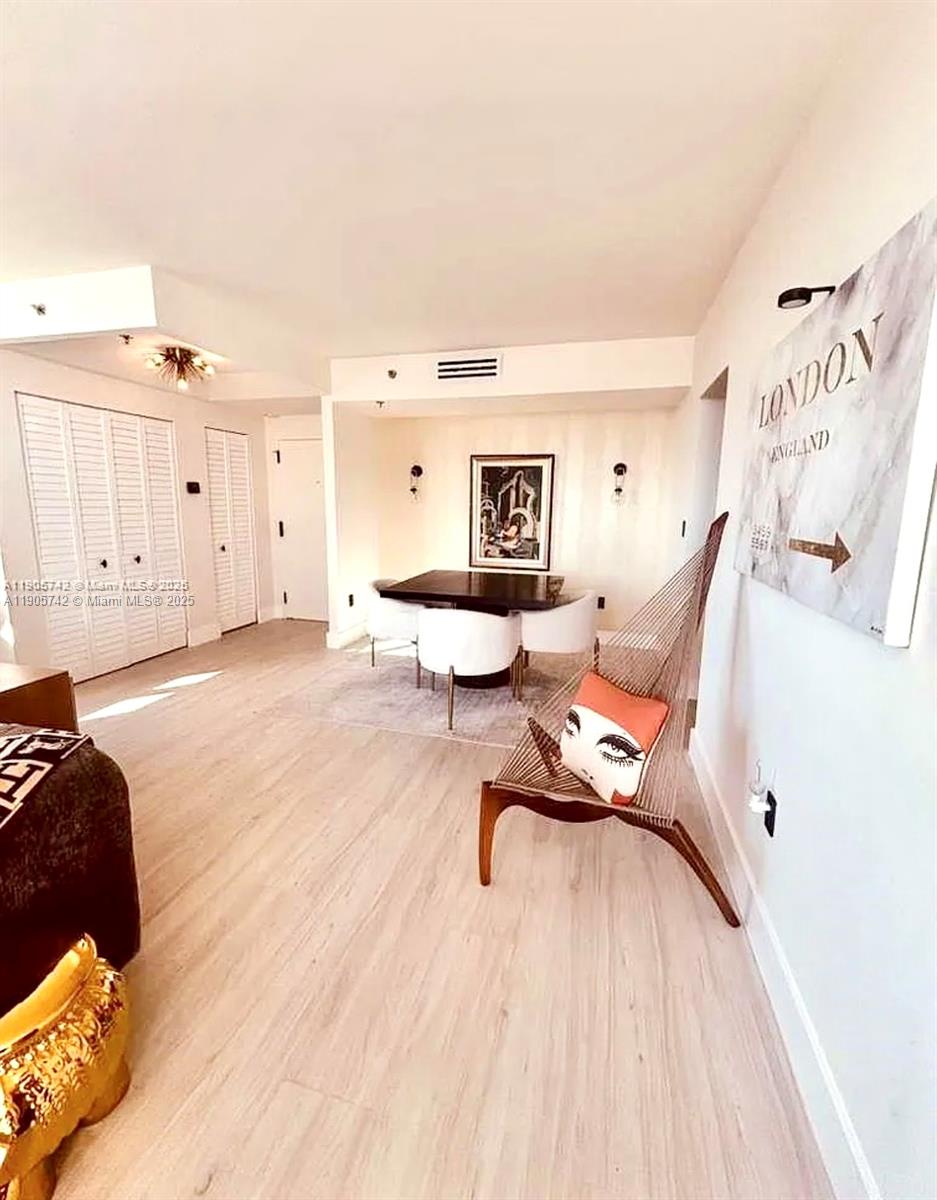 2829 Indian Creek Drive, Unit 603 Miami Beach, FL 33140 - Photo 7 of 28 a living room with furniture and a wooden floor