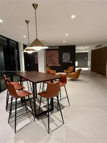 a view of a hallway and a livingroom with furniture