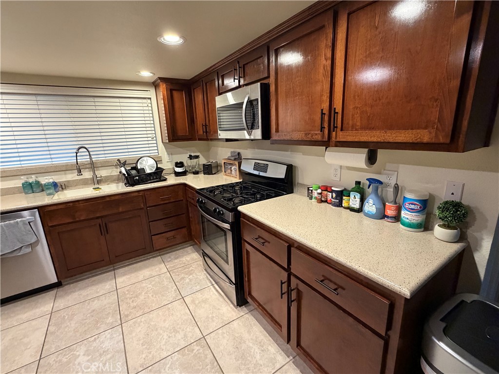 209 Kimberly Lane Ridgecrest, CA 93555 - Photo 15 of 62 a kitchen with a sink a stove cabinets and a window