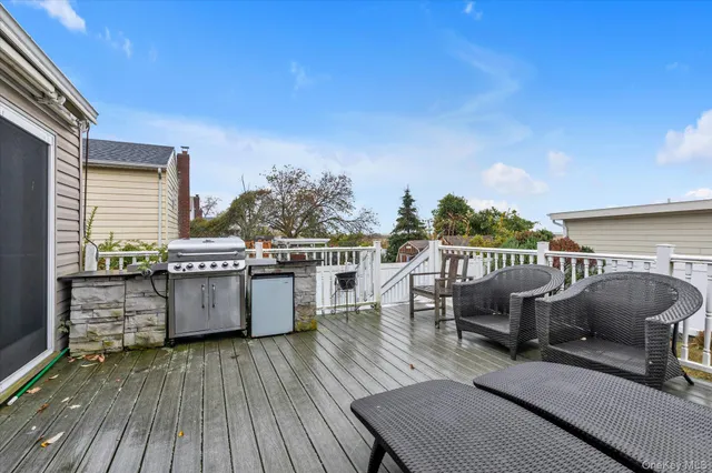 a view of a roof deck with chair and wooden floor