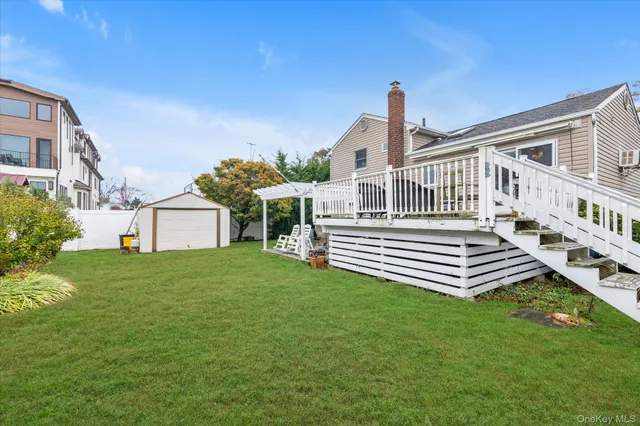 a front view of a house with a garden and deck