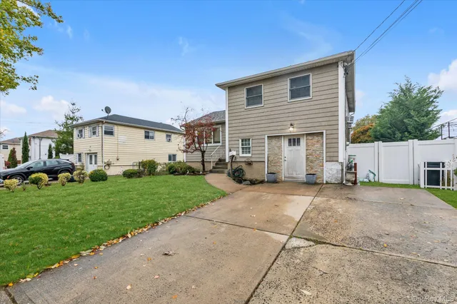 a view of a house with a yard and deck