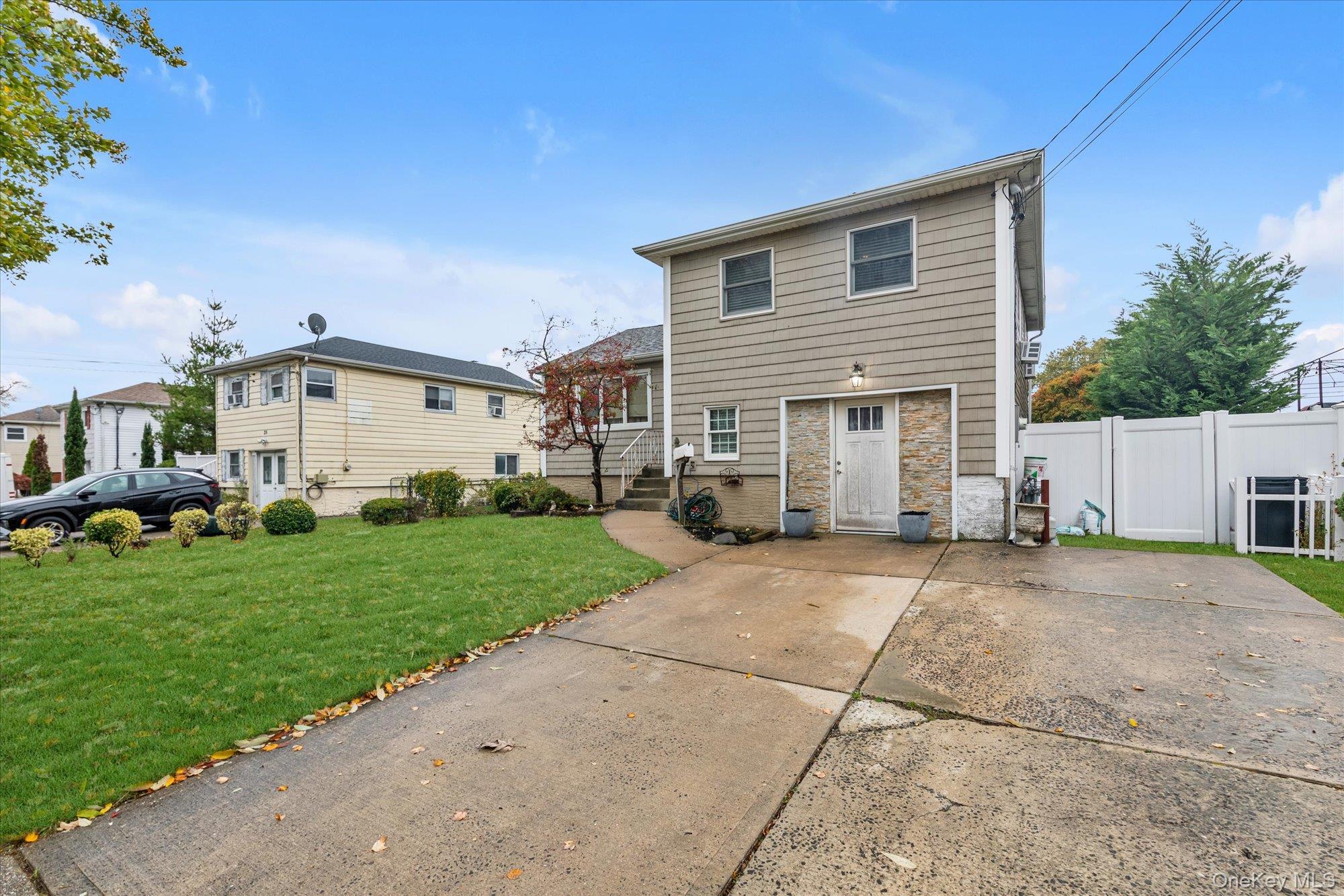 26 Cheshire Road Inwood, NY 11096 - Photo 21 of 22 a view of a house with a yard