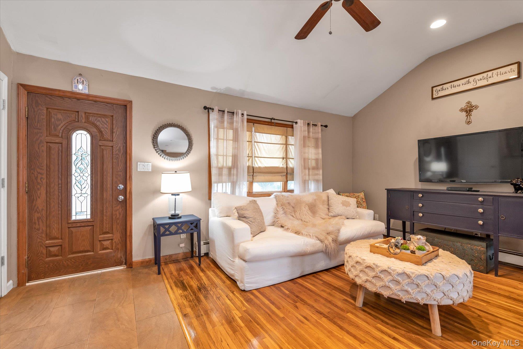 26 Cheshire Road Inwood, NY 11096 - Photo 3 of 22 a living room with furniture and a flat screen tv