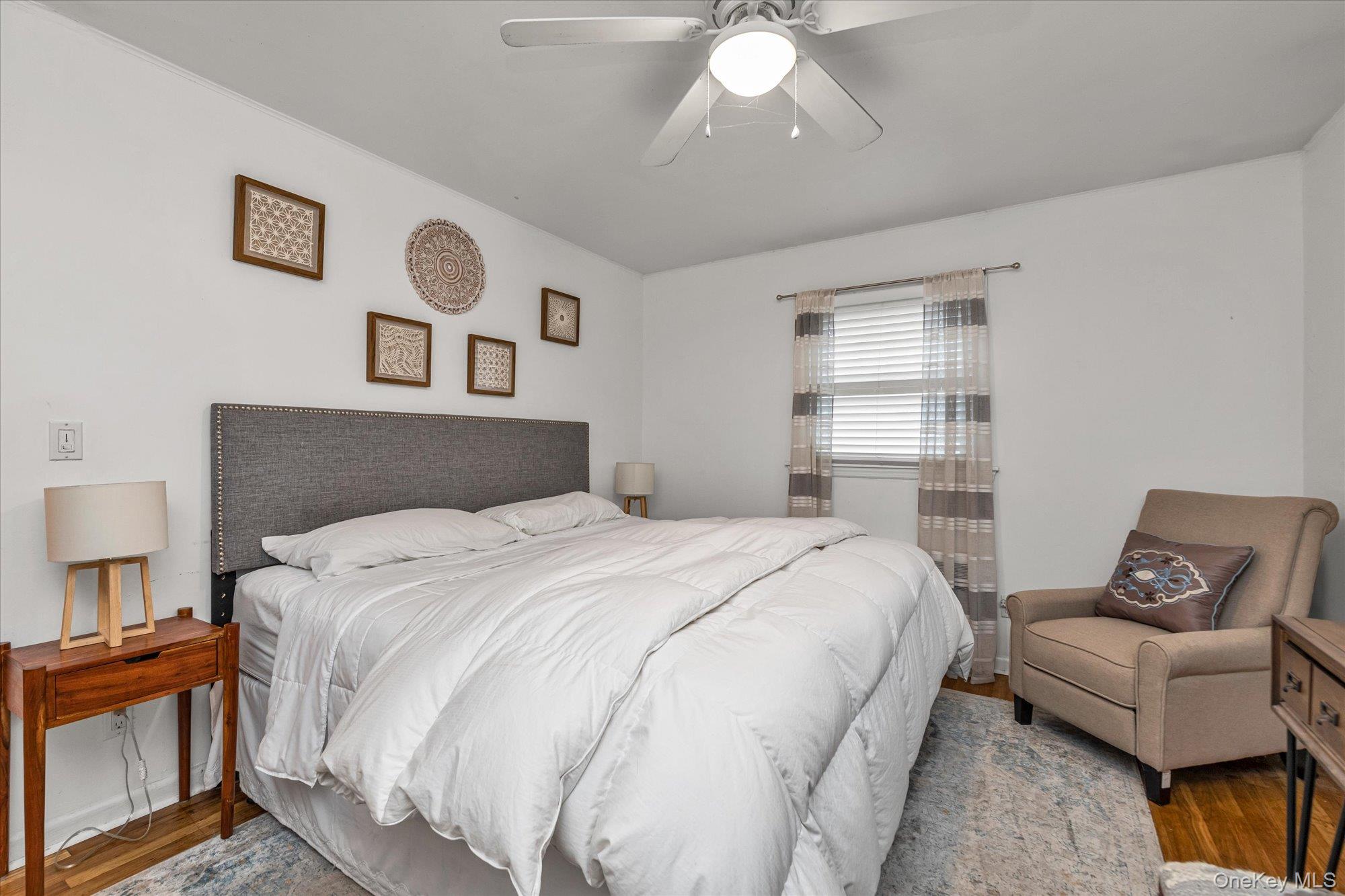 26 Cheshire Road Inwood, NY 11096 - Photo 8 of 22 Bedroom with wood finished floors and a ceiling fan