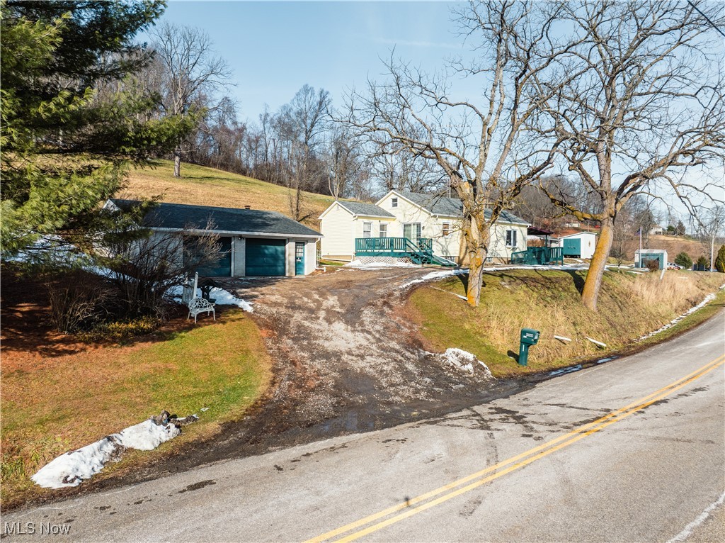 View of front of property with driveway, a garage, and a front yard