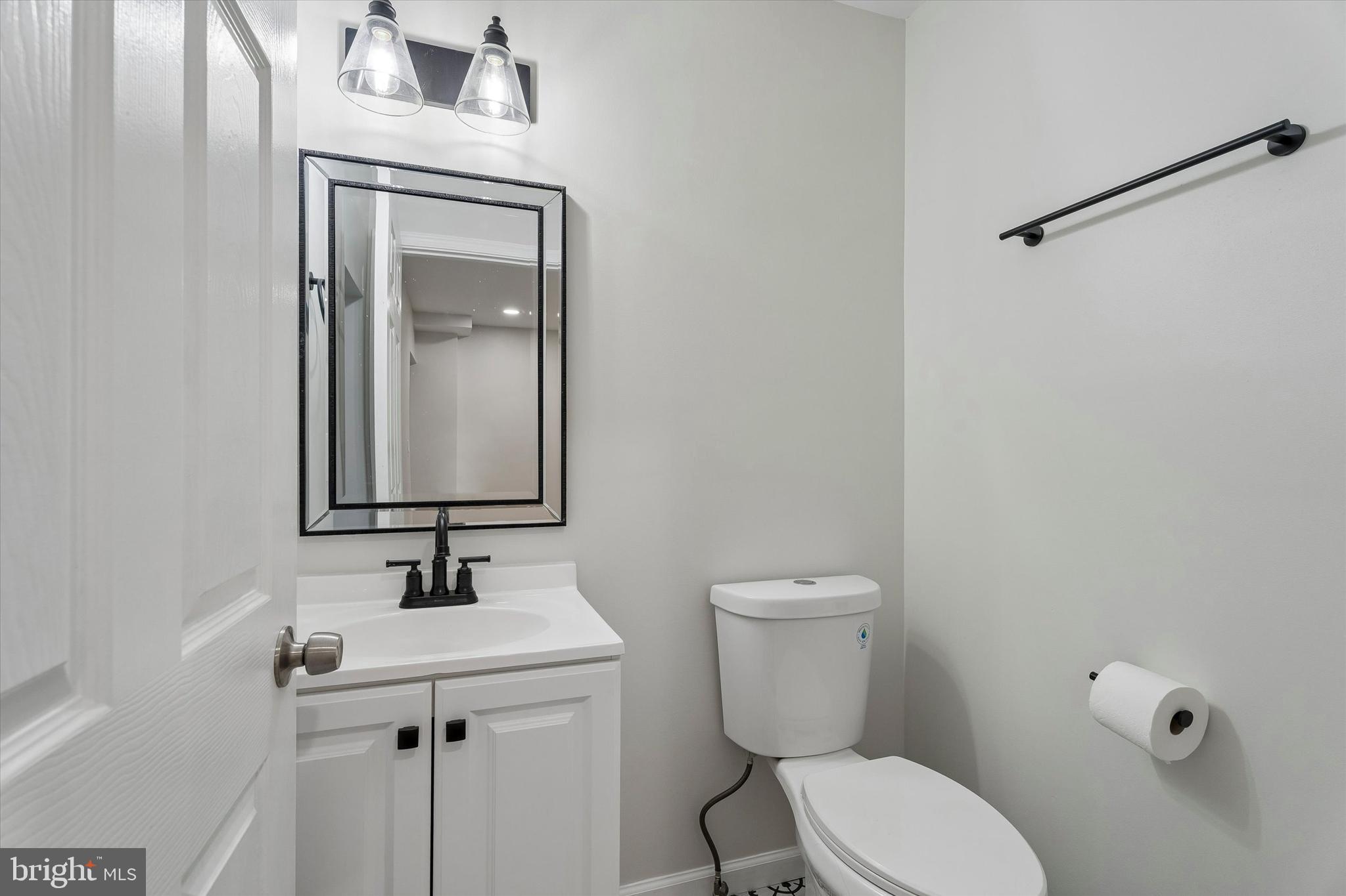 4359 Fleming Street Philadelphia, PA 19128 - Photo 20 of 43 a bathroom with a toilet a sink and mirror