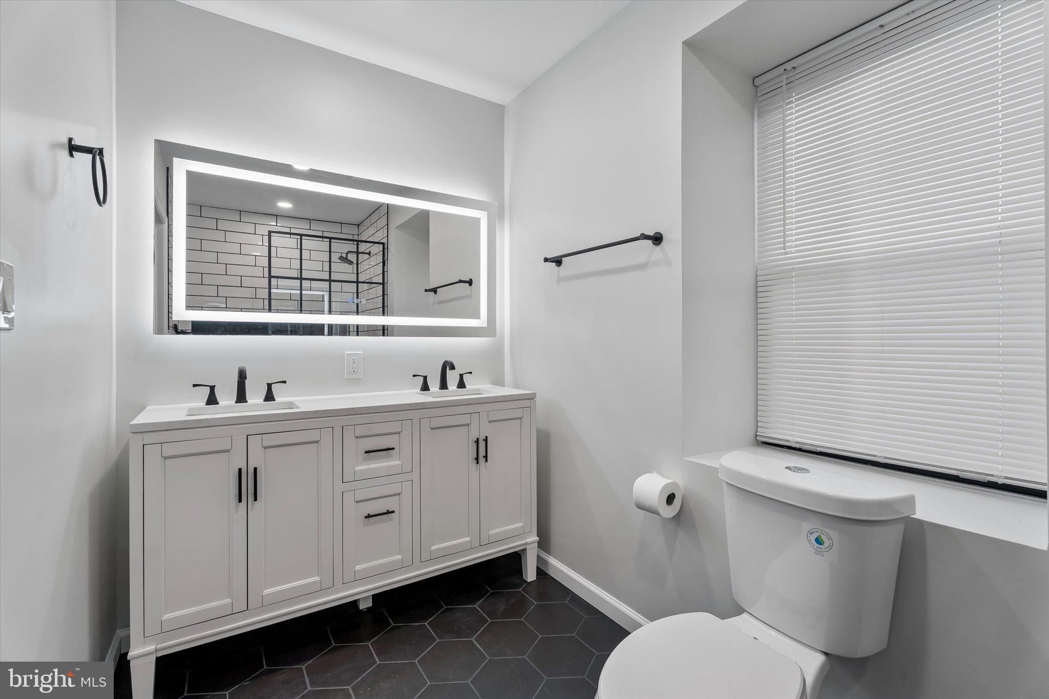 4359 Fleming Street Philadelphia, PA 19128 - Photo 33 of 43 a bathroom with a toilet sink and mirror