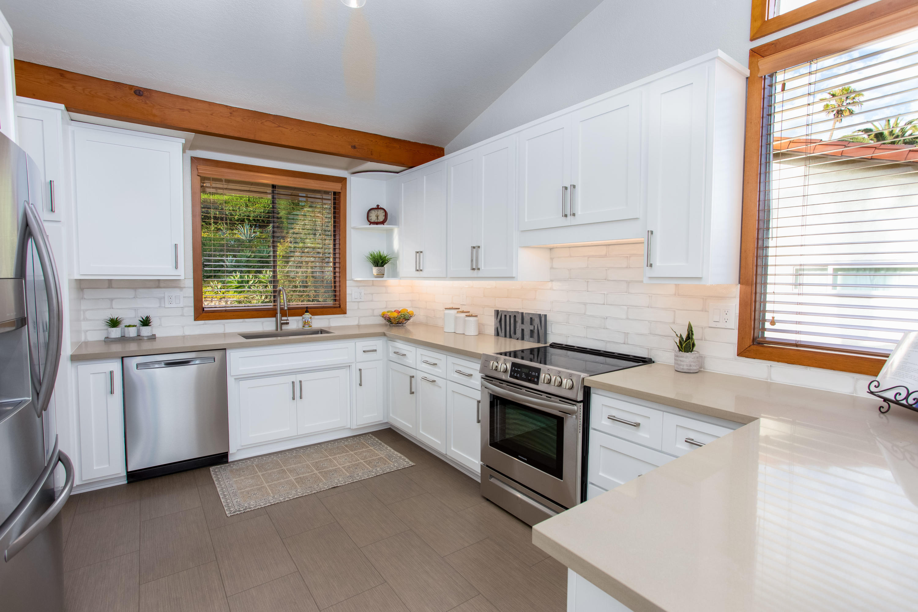 624 Las Alturas Road Santa Barbara, CA 93103 - Photo 12 of 40 a kitchen with granite countertop white cabinets and white appliances