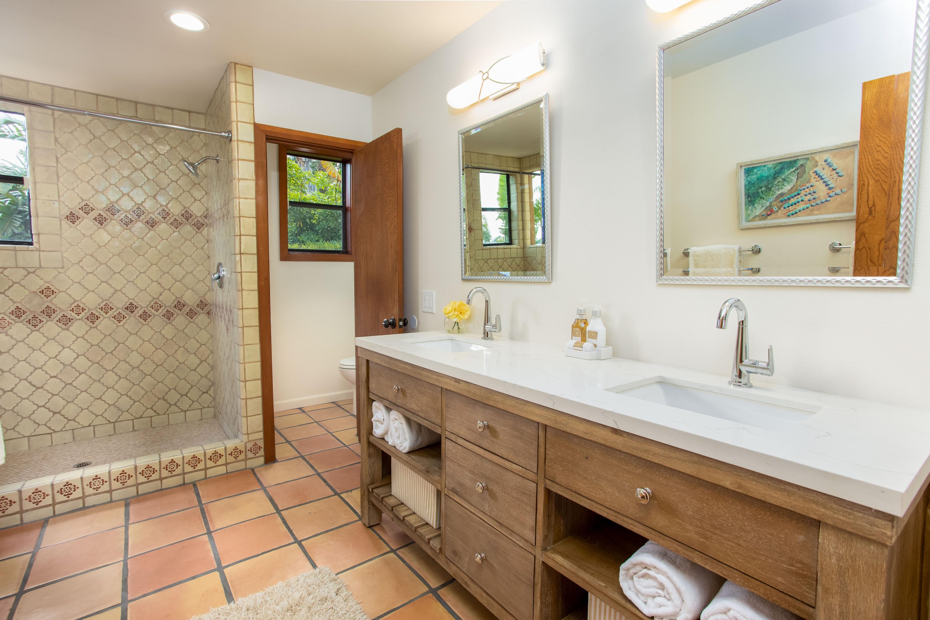 624 Las Alturas Road Santa Barbara, CA 93103 - Photo 17 of 40 a spacious bathroom with a granite countertop sink a mirror and a shower