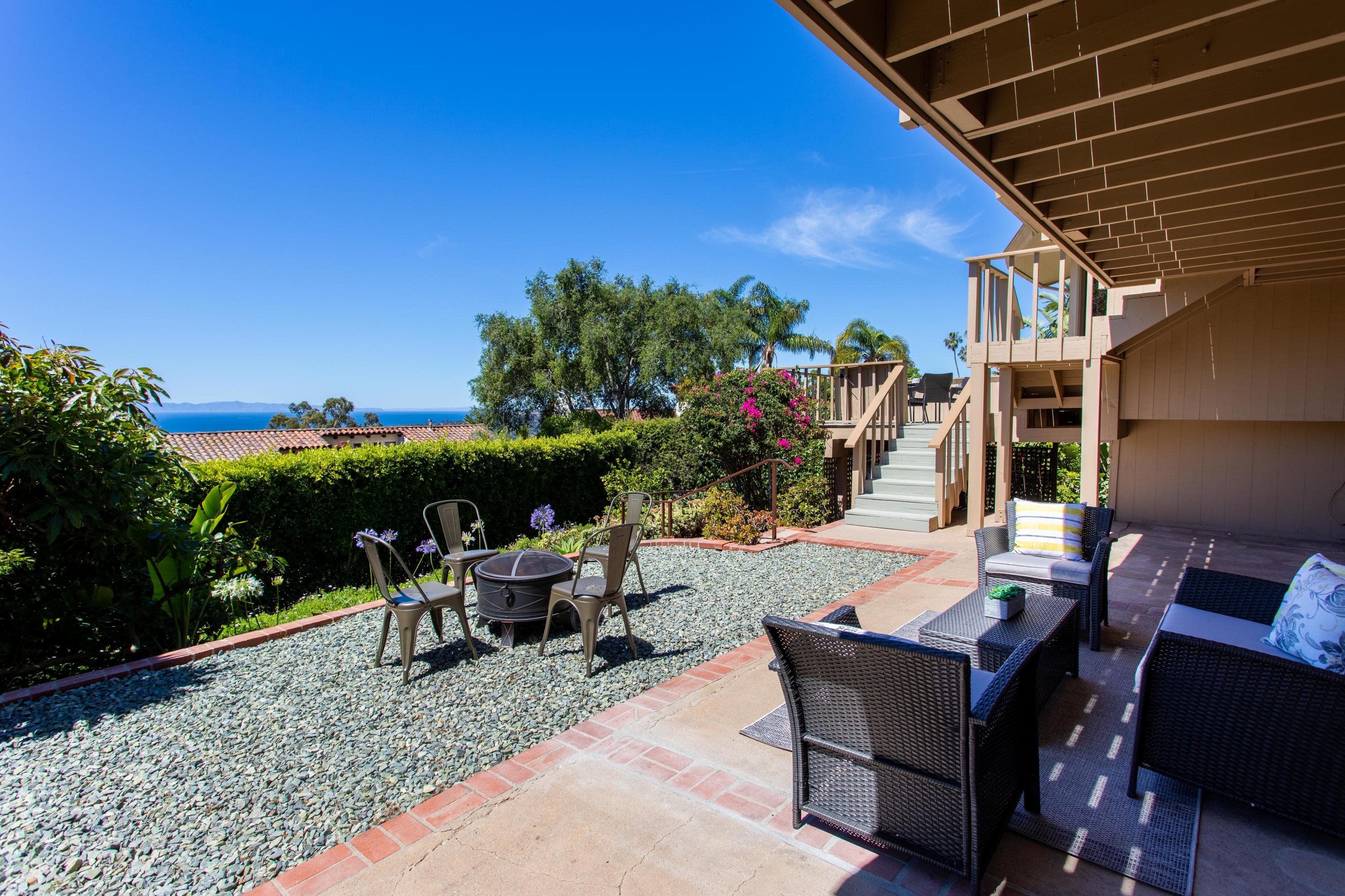 624 Las Alturas Road Santa Barbara, CA 93103 - Photo 28 of 40 a view of a patio with a table and chairs under an umbrella