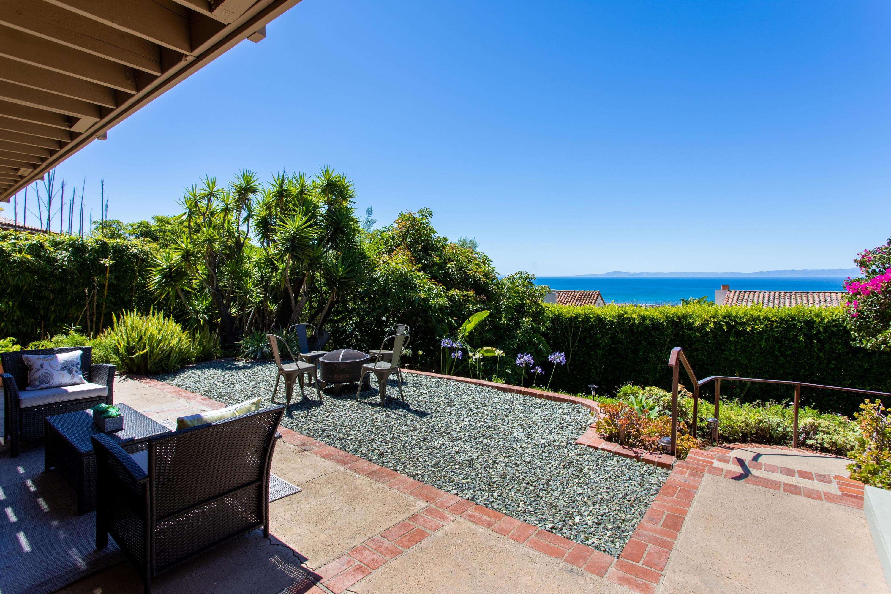 624 Las Alturas Road Santa Barbara, CA 93103 - Photo 29 of 40 a view of a patio with couches and table and chairs and potted plants