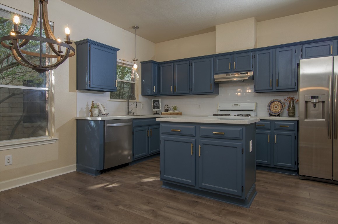 8001 Luling Lane Austin, TX 78729 - Photo 1 of 1 a kitchen with a sink a stove and cabinets
