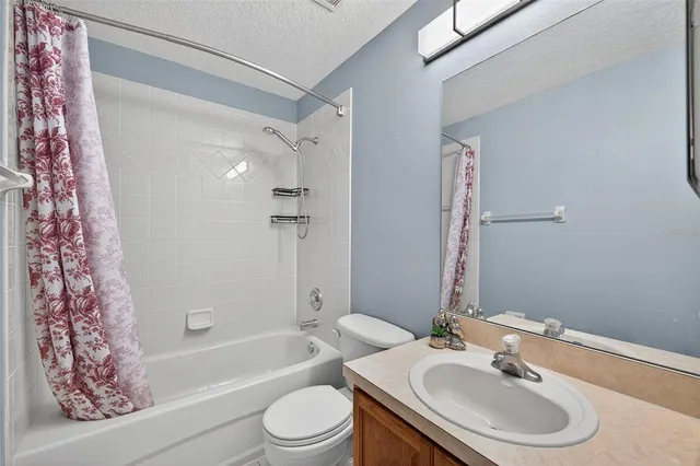 a bathroom with a sink toilet and mirror