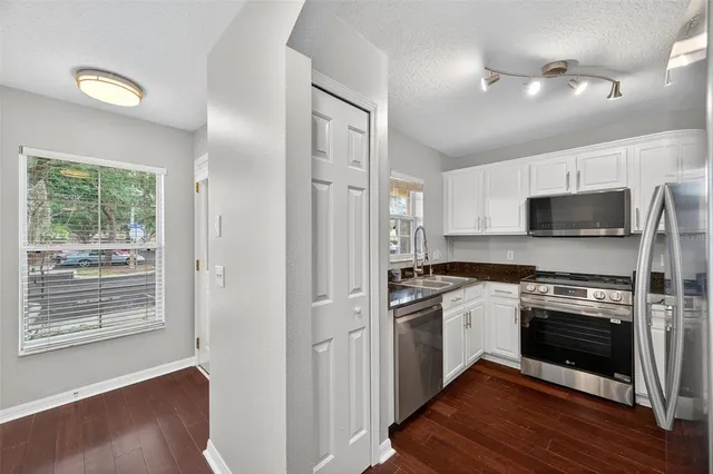 a kitchen with stainless steel appliances granite countertop a stove and a refrigerator