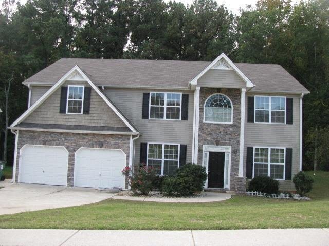 353 Oakhaven Way Villa Rica, GA 30180 - Photo 1 of 1 a front view of a house with a yard and garage
