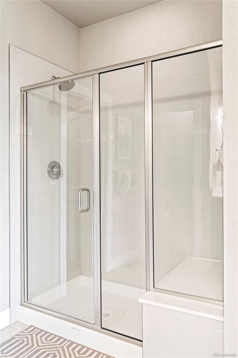 460 Elk Track Circle Granby, CO 80446 - Photo 16 of 26 a bathroom with a glass shower door